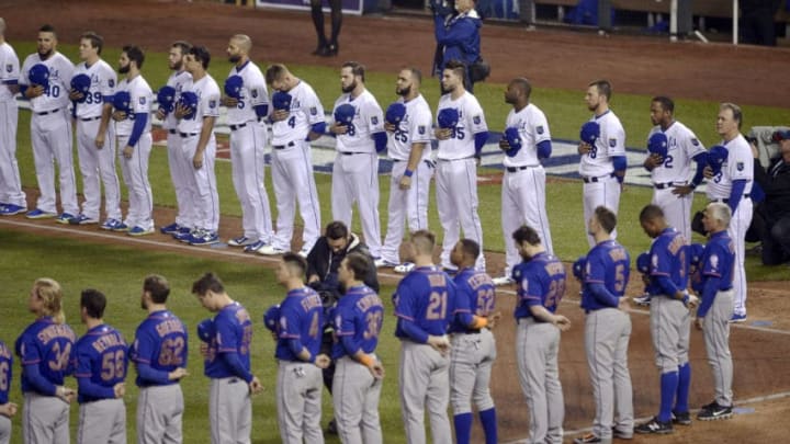 The Kansas City Royals and the New York Mets line up for the playing of the national anthem before Game 1 of the World Series on Tuesday, Oct. 27, 2015, at Kauffman Stadium in Kansas City, Mo. (Joe Ledford/Kansas City Star/TNS via Getty Images)