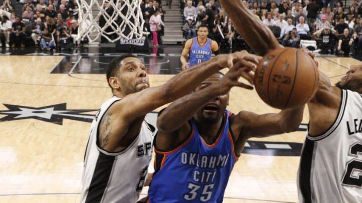 May 10, 2016; San Antonio, TX, USA; Oklahoma City Thunder small forward Kevin Durant (35) grabs a rebound as San Antonio Spurs power forward Tim Duncan (21, left) and small forward Kawhi Leonard (2, right) defend in game five of the second round of the NBA Playoffs at AT&T Center. Mandatory Credit: Soobum Im-USA TODAY Sports