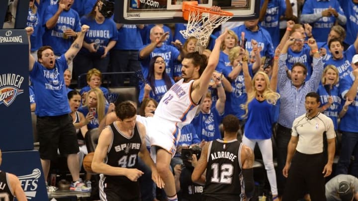 May 12, 2016; Oklahoma City, OK, USA; Oklahoma City Thunder center Steven Adams (12) dunks the ball over San Antonio Spurs center Boban Marjanovic (40) during the first quarter in game six of the second round of the NBA Playoffs at Chesapeake Energy Arena. Mandatory Credit: Mark D. Smith-USA TODAY Sports