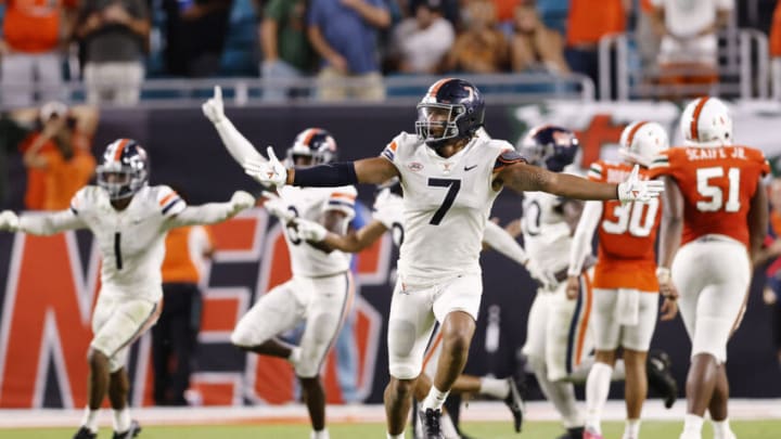 MIAMI GARDENS, FLORIDA - SEPTEMBER 30: Noah Taylor #7 of the Virginia Cavaliers celebrates after Andres Borregales #30 of the Miami Hurricanes missed a game-winning field goal as time expired during the second half at Hard Rock Stadium on September 30, 2021 in Miami Gardens, Florida. (Photo by Michael Reaves/Getty Images)
