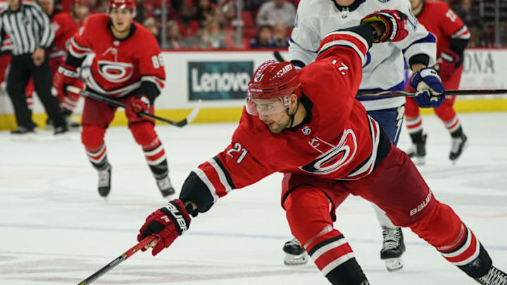 RALEIGH, NC - OCTOBER 06: Carolina Hurricanes Left Wing Nino Niederreiter (21) reaches for a puck during a game between the Tampa Bay Lightning and the Carolina Hurricanes at the PNC Arena in Raleigh, NC on October 6, 2019.(Photo by Greg Thompson/Icon Sportswire via Getty Images)