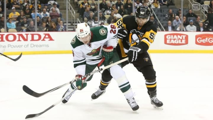 Nov 17, 2015; Pittsburgh, PA, USA; Minnesota Wild left wing Thomas Vanek (26) and Pittsburgh Penguins defenseman Kris Letang (58) battle for position while chasing a loose puck during the third period at the CONSOL Energy Center. The Penguins won 4-3. Mandatory Credit: Charles LeClaire-USA TODAY Sports