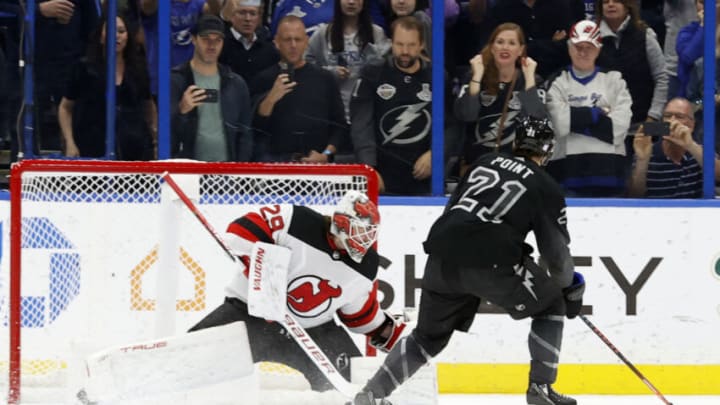 Nov 20, 2021; Tampa, Florida, USA; Tampa Bay Lightning center Brayden Point (21) shoots as New Jersey Devils goaltender Mackenzie Blackwood (29) defends during the third period at Amalie Arena. Mandatory Credit: Kim Klement-USA TODAY Sports