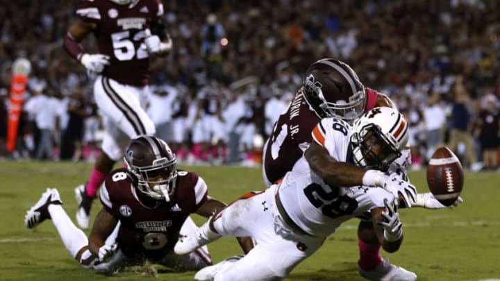 STARKVILLE, MS - OCTOBER 06: JaTarvious Whitlow #28 of the Auburn Tigers fumbles the ball as Mark McLaurin #41 and Maurice Smitherman #8 of the Mississippi State Bulldogs defend during the second half at Davis Wade Stadium on October 6, 2018 in Starkville, Mississippi. (Photo by Jonathan Bachman/Getty Images)
