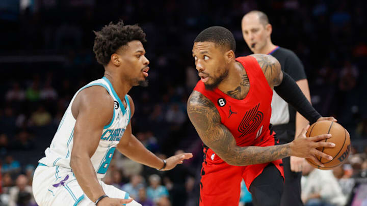 Nov 9, 2022; Charlotte, North Carolina, USA; Portland Trail Blazers guard Damian Lillard, right, looks to drive against Charlotte Hornets guard Dennis Smith Jr. (8) during the first quarter at Spectrum Center. Mandatory Credit: Nell Redmond-USA TODAY Sports