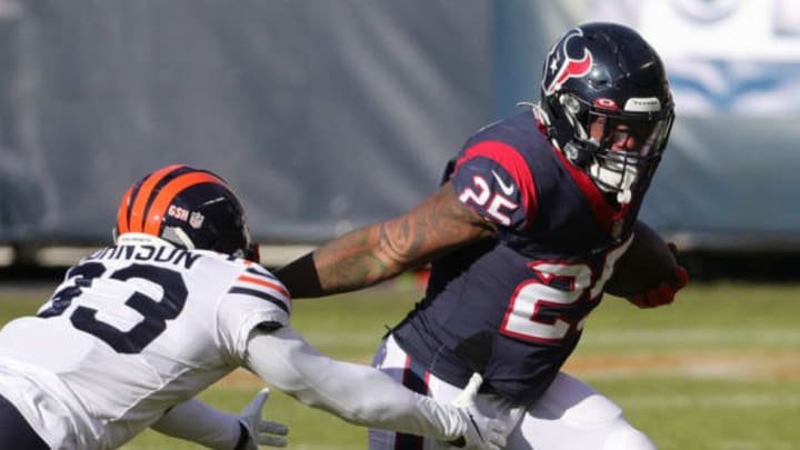 CHICAGO, ILLINOIS – DECEMBER 13: Houston Texans running back Duke Johnson #25 runs against Chicago Bears cornerback Jaylon Johnson #33 during the first half at Soldier Field on December 13, 2020 in Chicago, Illinois. (Photo by Jonathan Daniel/Getty Images)