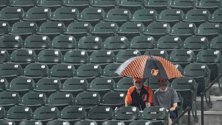 BALTIMORE, MD - SEPTEMBER 14: Fans watch the game in the rain between the Baltimore Orioles and the Chicago White Sox in the sixth inning against the at Oriole Park at Camden Yards on September 14, 2018 in Baltimore, Maryland. (Photo by Greg Fiume/Getty Images)