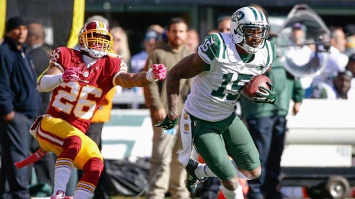 Oct 18, 2015; East Rutherford, NJ, USA; New York Jets wide receiver Brandon Marshall (15) carries the ball past Washington Redskins cornerback Bashaud Breeland (26) in the second half against the Washington Redskins at MetLife Stadium. The Jets won 34-20. Mandatory Credit: Vincent Carchietta-USA TODAY Sports