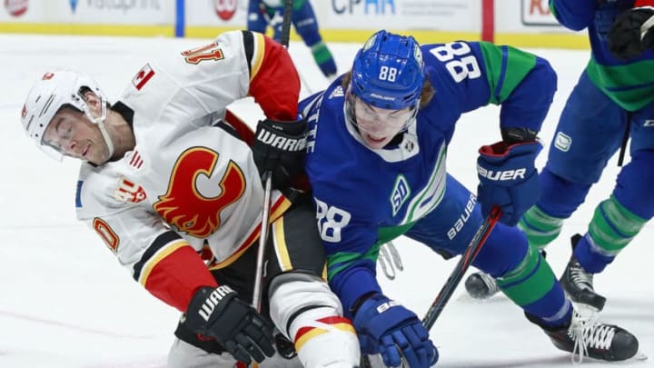 VANCOUVER, BC - FEBRUARY 8: Adam Gaudette #88 of the Vancouver Canucks checks Derek Ryan #10 of the Calgary Flames during their NHL game at Rogers Arena February 8, 2020 in Vancouver, British Columbia, Canada. (Photo by Jeff Vinnick/NHLI via Getty Images)