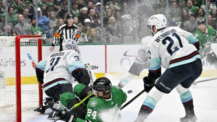 May 11, 2023; Dallas, Texas, USA; Dallas Stars center Roope Hintz (24) is tripped up in front of Seattle Kraken goaltender Philipp Grubauer (31) and center Alex Wennberg (21) during the second period in game five of the second round of the 2023 Stanley Cup Playoffs at American Airlines Center. Mandatory Credit: Jerome Miron-USA TODAY Sports
