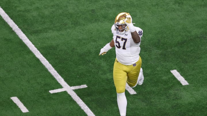 ARLINGTON, TEXAS – JANUARY 01: Jayson Ademilola #57 of the Notre Dame Fighting Irish reacts against the Alabama Crimson Tide during the second quarter in the 2021 College Football Playoff Semifinal Game at the Rose Bowl Game presented by Capital One at AT&T Stadium on January 01, 2021, in Arlington, Texas. (Photo by Carmen Mandato/Getty Images)