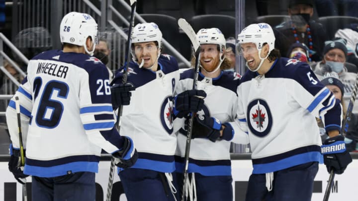 SEATTLE, WASHINGTON - DECEMBER 09: Kyle Connor #81 of the Winnipeg Jets celebrates his goal with teammates during the third period against the Seattle Kraken at Climate Pledge Arena on December 09, 2021 in Seattle, Washington. (Photo by Steph Chambers/Getty Images)