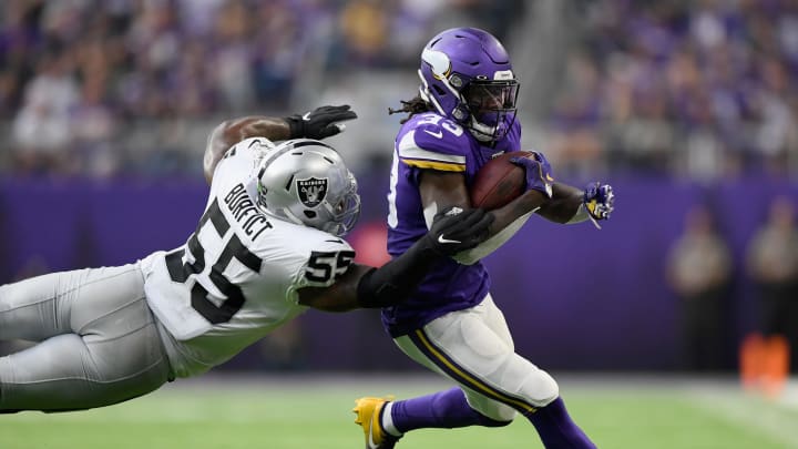 MINNEAPOLIS, MINNESOTA – SEPTEMBER 22: Dalvin Cook #33 of the Minnesota Vikings avoids a tackle by Vontaze Burfict #55 of the Oakland Raiders during the second quarter of the game at U.S. Bank Stadium on September 22, 2019, in Minneapolis, Minnesota. (Photo by Hannah Foslien/Getty Images)