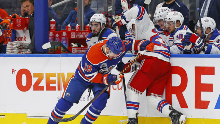 Oct 26, 2023; Edmonton, Alberta, CAN; Edmonton Oilers forward Zach Hyman (18) and New York Rangers defensemen Adam Fox (23) battle along the boards for a loose puck during the third period at Rogers Place. Mandatory Credit: Perry Nelson-USA TODAY Sports