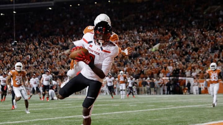 AUSTIN, TX - NOVEMBER 24: T.J. Vasher #9 of the Texas Tech Red Raiders catches a pass for a touchdown defended by Davante Davis #18 of the Texas Longhorns in the fourth quarter at Darrell K Royal-Texas Memorial Stadium on November 24, 2017 in Austin, Texas. (Photo by Tim Warner/Getty Images)