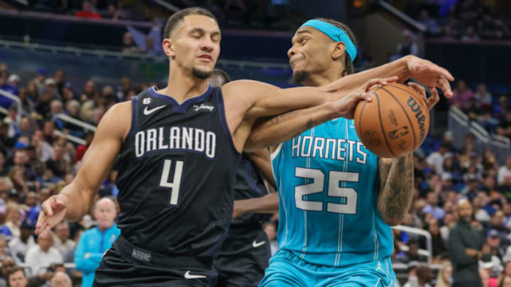 Orlando Magic guard Jalen Suggs (4) defends Charlotte Hornets forward P.J. Washington. Mandatory Credit: Mike Watters-USA TODAY Sports Orlando Magic guard Jalen Suggs (4) defends Charlotte Hornets forward P.J. Washington. Mandatory Credit: Mike Watters-USA TODAY Sports