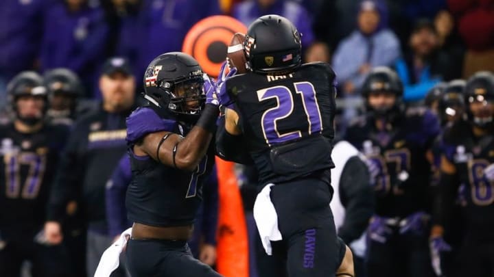 Nov 12, 2016; Seattle, WA, USA; Washington Huskies defensive back Taylor Rapp (21) intercepts a pass with help from Washington Huskies linebacker Keishawn Bierria (7) against the USC Trojans during the first quarter at Husky Stadium. Mandatory Credit: Joe Nicholson-USA TODAY Sports