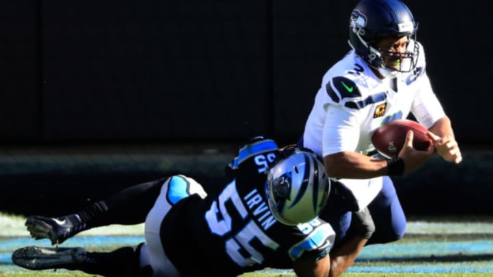 CHARLOTTE, NORTH CAROLINA - DECEMBER 15: Seattle Seahawks quarterback Russell Wilson #3 is sacked by Carolina Panthers linebacker Bruce Irvin #55 in the first half at Bank of America Stadium on December 15, 2019 in Charlotte, North Carolina. (Photo by Streeter Lecka/Getty Images)