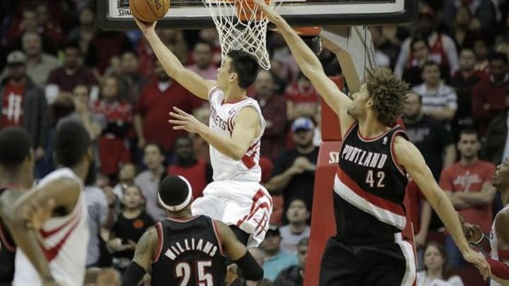 Mar 9, 2014; Houston, TX, USA; Houston Rockets point guard Jeremy Lin (7) scores against Portland Trail Blazers center Robin Lopez (42) during the overtime period at Toyota Center. Mandatory Credit: Andrew Richardson-USA TODAY Sports