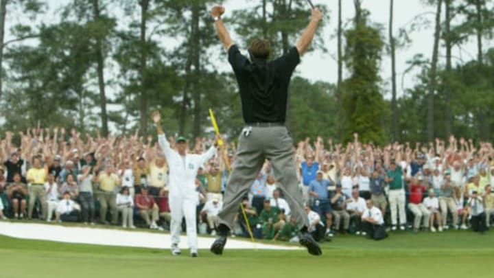 Phil Mickelson jumps in the air after sinking his birdie putt to win the Masters by one shot on the 18th green during the final round of the Masters at the Augusta National Golf Club on April 11, 2004 in Augusta, Georgia. (Photo by Andrew Redington/Getty Images)