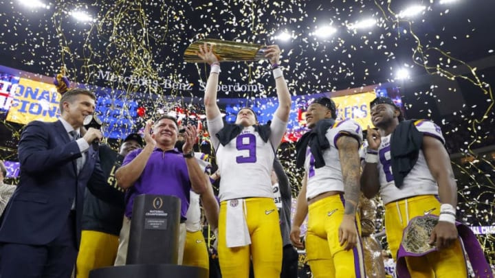 NEW ORLEANS, LOUISIANA - JANUARY 13: Head coach Ed Orgeron of the LSU Tigers, Joe Burrow #9 of the LSU Tigers and Grant Delpit #7 of the LSU Tigers celebrate with the trophy after defeating the Clemson Tigers 42-25 in the College Football Playoff National Championship game at Mercedes Benz Superdome on January 13, 2020 in New Orleans, Louisiana. (Photo by Kevin C. Cox/Getty Images)