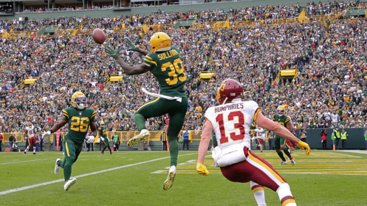 GREEN BAY, WISCONSIN - OCTOBER 24: Chandon Sullivan #39 of the Green Bay Packers intercepts a pass intended for Adam Humphries #13 of the Washington Football Team during a game at Lambeau Field on October 24, 2021 in Green Bay, Wisconsin. (Photo by Stacy Revere/Getty Images)