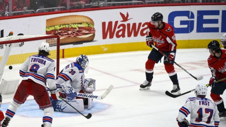 WASHINGTON, DC - OCTOBER 18: Washington Capitals right wing T.J. Oshie (77) scores a third period goal against New York Rangers goaltender Henrik Lundqvist (30) on October 18, 2019, at the Capital One Arena in Washington, D.C. (Photo by Mark Goldman/Icon Sportswire via Getty Images)