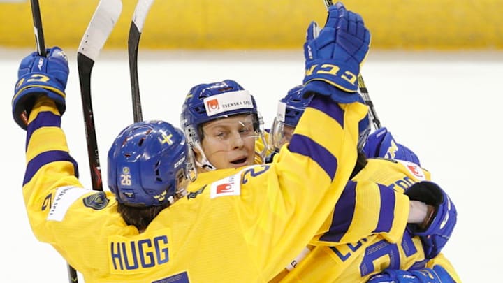 VICTORIA , BC - DECEMBER 26: Adam Boqvist #3, Rickard Hugg #26 and Isac Lundestrom #22 of Sweden celebrate a goal versus Finland at the IIHF World Junior Championships at the Save-on-Foods Memorial Centre on December 26, 2018 in Victoria, British Columbia, Canada. (Photo by Kevin Light/Getty Images)