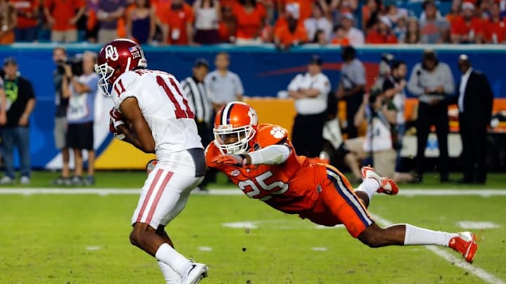 Dec 31, 2015; Miami Gardens, FL, USA; Oklahoma Sooners wide receiver Dede Westbrook (11) catches the ball as Clemson Tigers cornerback Cordrea Tankersley (25) tackles in the second quarter of the 2015 CFP Semifinal at the Orange Bowl at Sun Life Stadium. Mandatory Credit: Kim Klement-USA TODAY Sports