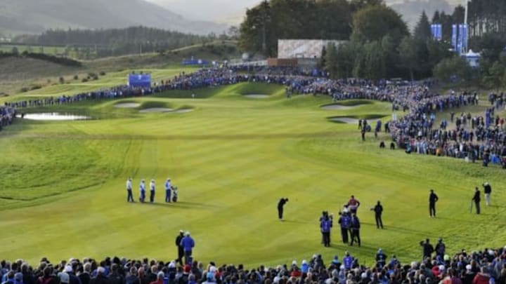 Sep 27, 2014; Gleneagles, Perthshire, SCT; Ian Poulter and Rory McIlroy watch as Rickie Fowler plays his shot on the fairway at the 2nd hole during their fourball match on day two of the 2014 Ryder Cup at Gleneagles Resort - PGA Centenary Course. Mandatory Credit: Ian Rutherford-USA TODAY Sports