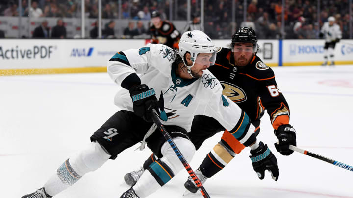 ANAHEIM, CALIFORNIA – SEPTEMBER 24: Brenden Dillon #4 of the San Jose Sharks turns as he is chased by Kiefer Sherwood #64 of the Anaheim Ducks during the first period in a preseason game at Honda Center on September 24, 2019 in Anaheim, California. (Photo by Harry How/Getty Images)