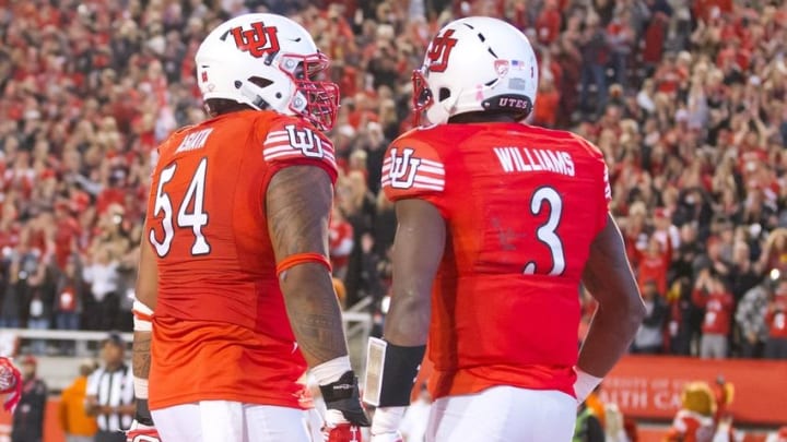 Oct 8, 2016; Salt Lake City, UT, USA; Utah Utes offensive lineman Isaac Asiata (54) and quarterback Troy Williams (3) react to a touchdown by Williams during the second half against the Arizona Wildcats at Rice-Eccles Stadium. Utah won 36-23. Mandatory Credit: Russ Isabella-USA TODAY Sports