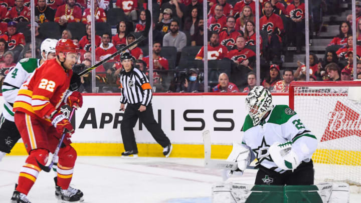 CALGARY, AB - MAY 3: Trevor Lewis #22 of the Calgary Flames takes a shot against Jake Oettinger #29 of the Dallas Stars during the third period of Game One of the First Round of the 2022 Stanley Cup Playoffs at Scotiabank Saddledome on May 3, 2022 in Calgary, Alberta, Canada. The Flames defeated the Stars 1-0. (Photo by Derek Leung/Getty Images)