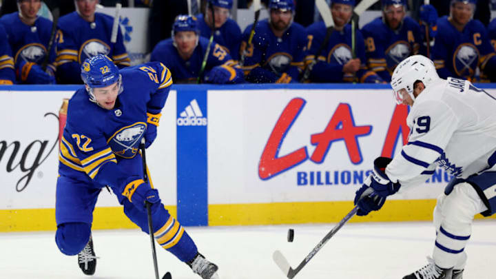 Feb 21, 2023; Buffalo, New York, USA; Buffalo Sabres right wing Jack Quinn (22) and Toronto Maple Leafs center Calle Jarnkrok (19) look to control a loose puck during the second period at KeyBank Center. Mandatory Credit: Timothy T. Ludwig-USA TODAY Sports