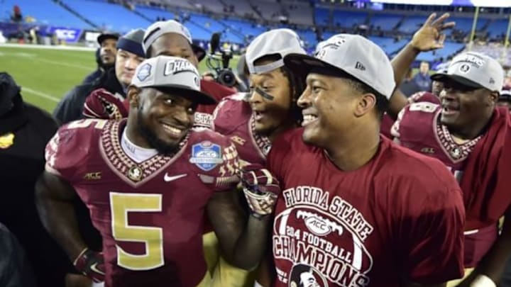 Dec 6, 2014; Charlotte, NC, USA; Florida State Seminoles linebacker Reggie Northrup (5) and quarterback Jameis Winston (5) celebrate after the game. The Florida State Seminoles defeated the Georgia Tech Yellow Jackets 37-35 at Bank of America Stadium. Mandatory Credit: Bob Donnan-USA TODAY Sports