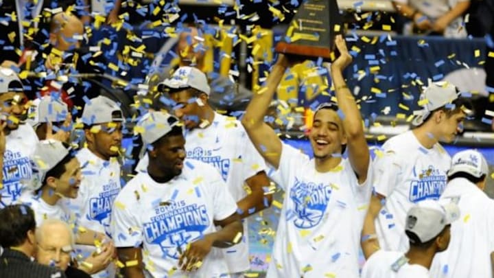 Mar 15, 2015; Nashville, TN, USA; Kentucky Wildcats players celebrate with the championship trophy after winning the SEC Conference Championship game against the Arkansas Razorbacks at Bridgestone Arena. Kentucky won 78-63. Mandatory Credit: Christopher Hanewinckel-USA TODAY Sports
