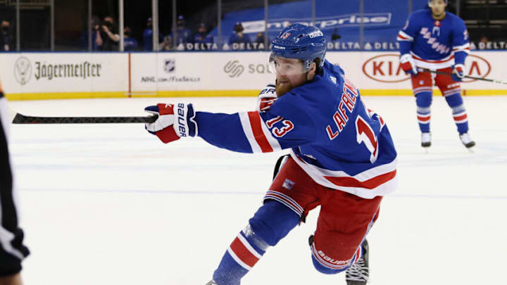 NEW YORK, NEW YORK - APRIL 27: Alexis Lafreniere #13 of the New York Rangers takes a slapshot against the Buffalo Sabres at Madison Square Garden on April 27, 2021 in New York City. The Rangers defeated the Sabres 3-1. (Photo by Bruce Bennett/Getty Images)