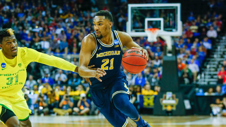 Mar 23, 2017; Kansas City, MO, USA; Michigan Wolverines guard Zak Irvin (21) drives around Oregon Ducks guard Dylan Ennis (31) during the first half in the semifinals of the midwest Regional of the 2017 NCAA Tournament at Sprint Center. Oregon defeated Michigan 69-68. Mandatory Credit: Jay Biggerstaff-USA TODAY Sports