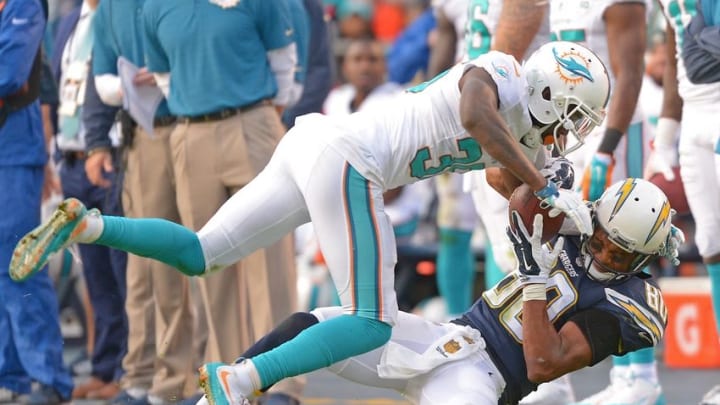 Dec 20, 2015; San Diego, CA, USA; San Diego Chargers wide receiver Malcom Floyd (80) hangs on to a 25 yard pass as Miami Dolphins defensive back Tony Lippett (36) defends the play in the third quarter of the game at Qualcomm Stadium. Mandatory Credit: Jayne Kamin-Oncea-USA TODAY Sports