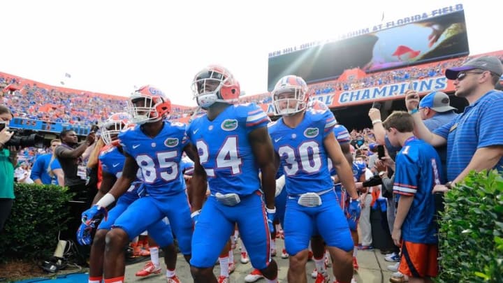 Nov 21, 2015; Gainesville, FL, USA; Florida Gators defensive back Brian Poole (24), wide receiver Chris Thompson (85) and teammates runs out of the tunnel before the game against the Florida Atlantic Owls at Ben Hill Griffin Stadium. Mandatory Credit: Kim Klement-USA TODAY Sports