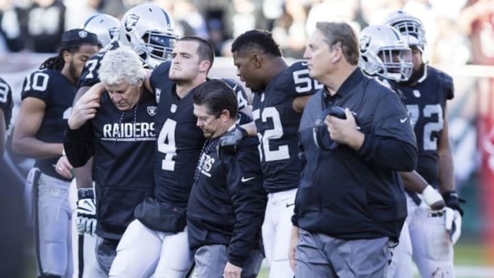 Dec 24, 2016; Oakland, CA, USA; Oakland Raiders quarterback Derek Carr (4) is helped off the field during the fourth quarter against the Indianapolis Colts at the Oakland Coliseum. The Oakland Raiders defeated the Indianapolis Colts 33-25. Mandatory Credit: Kelley L Cox-USA TODAY Sports