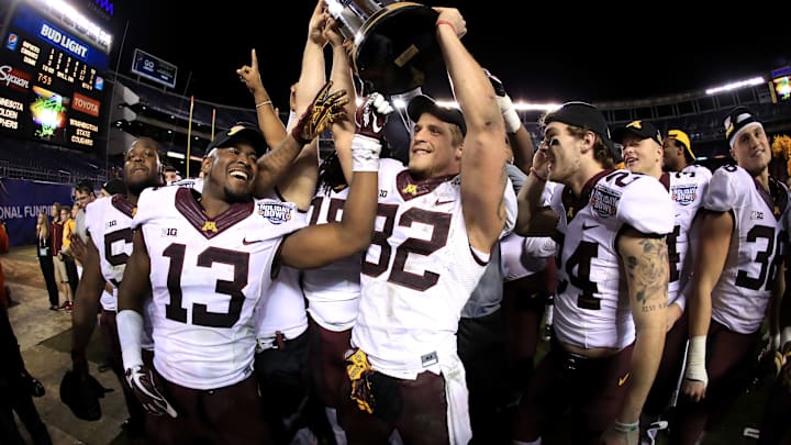 SAN DIEGO, CA – DECEMBER 27: Jonathan Celestin #13 and Emmit Carpenter #38 of the Minnesota Golden Gophers hold the championship trophy after defeating the Washington State Cougars 17-12 in the Holiday Bowl at at Qualcomm Stadium on December 27, 2016 in San Diego, California. (Photo by Sean M. Haffey/Getty Images)