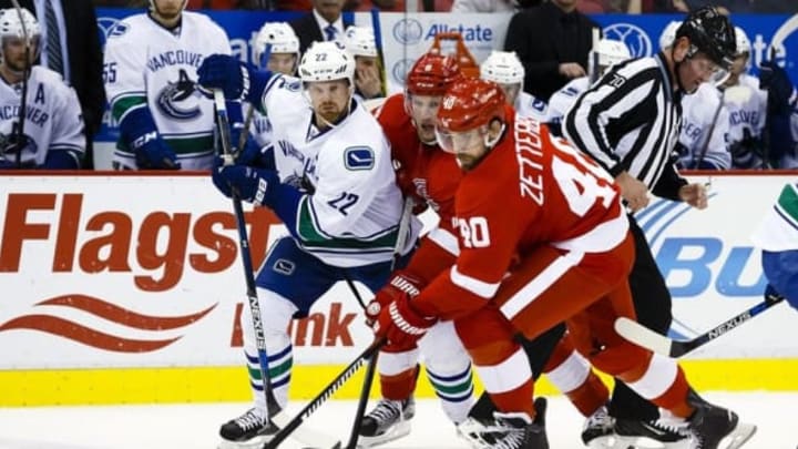 Dec 18, 2015; Detroit, MI, USA; Detroit Red Wings left wing Henrik Zetterberg (40) skates with the puck chased by Vancouver Canucks left wing Daniel Sedin (22) in the third period at Joe Louis Arena. Vancouver won 4-3 in a overtime shootout. Mandatory Credit: Rick Osentoski-USA TODAY Sports