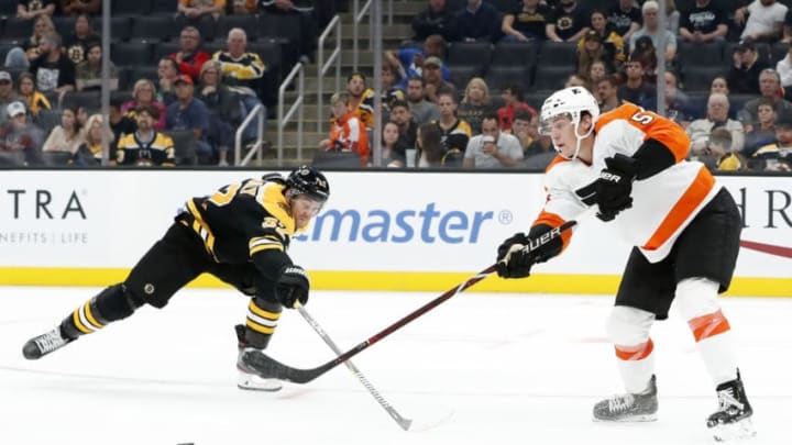 BOSTON, MA - SEPTEMBER 23: Philadelphia Flyers defenseman Phillippe Myers (5) passes the puck as Boston Bruins center Sean Kuraly (52) moves in during a preseason game between the Boston Bruins and the Philadelphia Flyers on September 23, 2019, at TD Garden in Boston, Massachusetts. (Photo by Fred Kfoury III/Icon Sportswire via Getty Images)