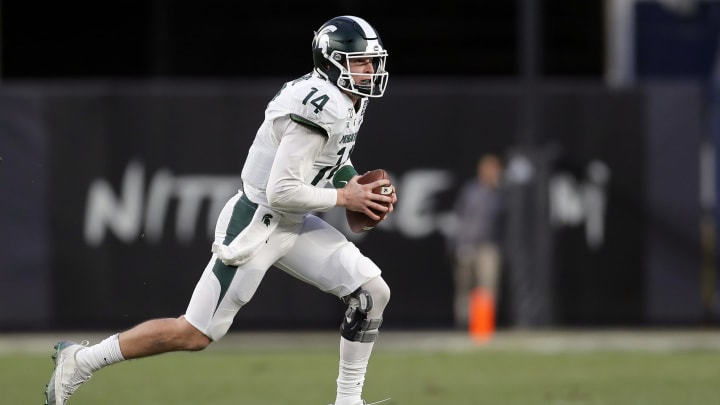 NEW YORK, NY – DECEMBER 27: Quarterback Brian Lewerke #14 of the Michigan State Spartans scrambles against the Wake Forest Demon Deacons during the first half of the New Era Pinstripe Bowl at Yankee Stadium on December 27, 2019 in the Bronx borough of New York City. (Photo by Adam Hunger/Getty Images)