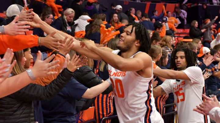 Nov 29, 2022; Champaign, Illinois, USA; Illinois Fighting Illini guard Ty Rodgers (20) and teammates get a hand from their fans after a 73-44 win over the Syracuse Orange at State Farm Center. Mandatory Credit: Ron Johnson-USA TODAY Sports