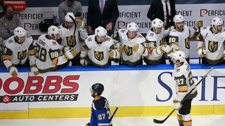 Shea Theodore #27 of the Vegas Golden Knights is congratulated by his teammates after scoring a goal against the St. Louis Blues during the second period in a Western Conference Round Robin game.