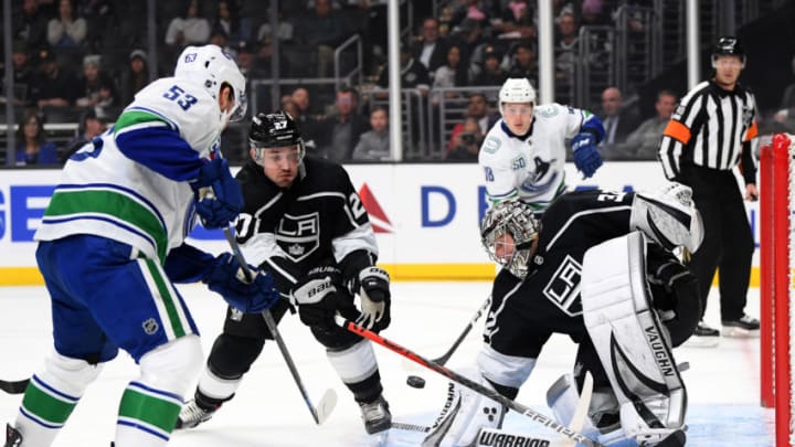 LOS ANGELES, CALIFORNIA - OCTOBER 30: Jonathan Quick #32 of the Los Angeles Kings makes a save on a shot from Bo Horvat #53 of the Vancouver Canucks as Alec Martinez #27 attempt to clear the rebound during the first period at Staples Center on October 30, 2019 in Los Angeles, California. (Photo by Harry How/Getty Images)