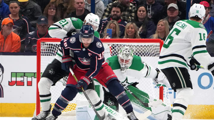COLUMBUS, OHIO – NOVEMBER 09: Boone Jenner #38 of the Columbus Blue Jackets controls the puck in front of Jason Robertson #21 of the Dallas Stars and Jake Oettinger #29 of the Dallas Stars during the first period at Nationwide Arena on November 09, 2023 in Columbus, Ohio. (Photo by Jason Mowry/Getty Images)