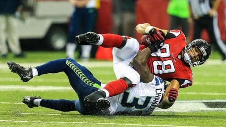Nov 10, 2013; Atlanta, GA, USA; Atlanta Falcons tight end Tony Gonzalez (88) is tackled by Seattle Seahawks safety Kam Chancellor (31) after a catch in the second half at the Georgia Dome. The Seahawks won 33-10. Mandatory Credit: Daniel Shirey-USA TODAY Sports